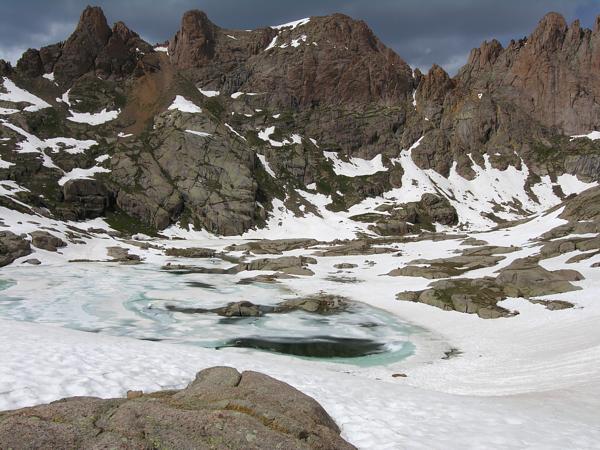 Looking west down at Twin Lakes, still mostly iced up on July 4th, and while descending from Mt Windom, San Juan Mountains, Colorado